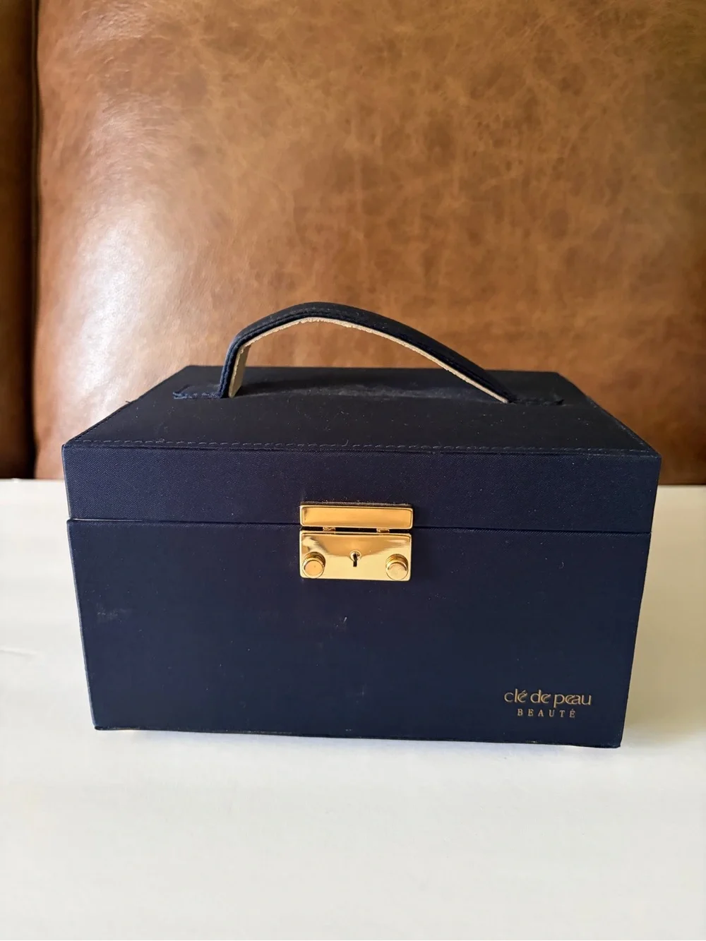 NWOT Cle’ de Peau elegant blue satin small/travel jewelry box. Mirror. Drawer